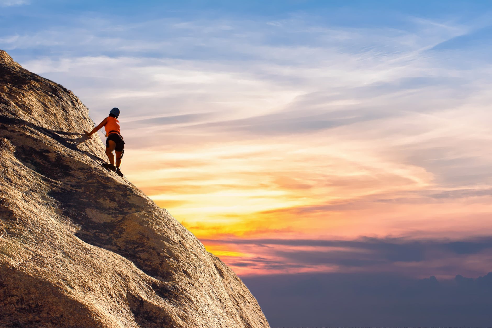 Woman climbing a mountain.