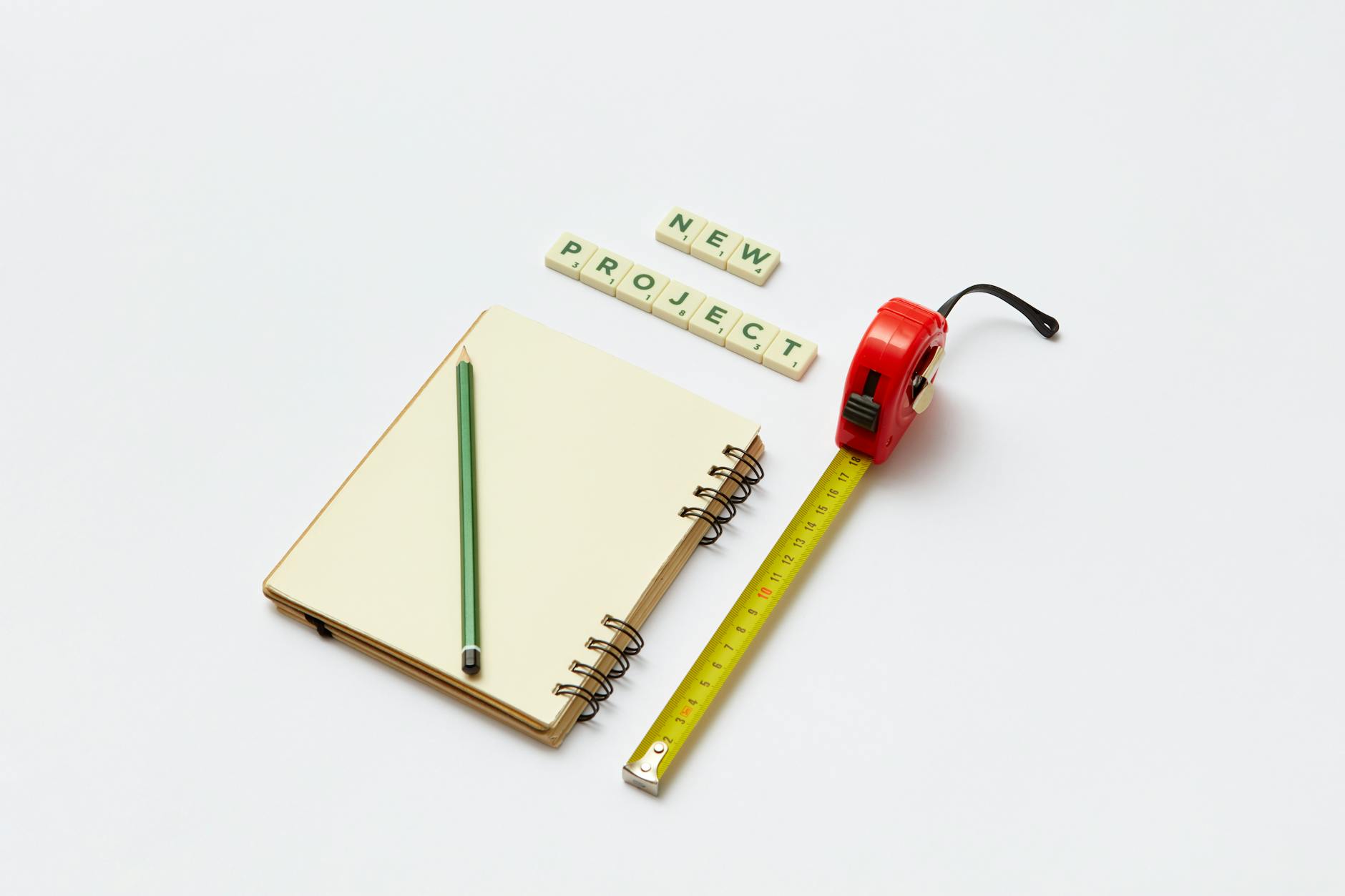 Image of a pad and ruler showing the importance of writing goals and measuring progress. Leaders work with others to not only set goals, but help them along the way to achieve those goals.